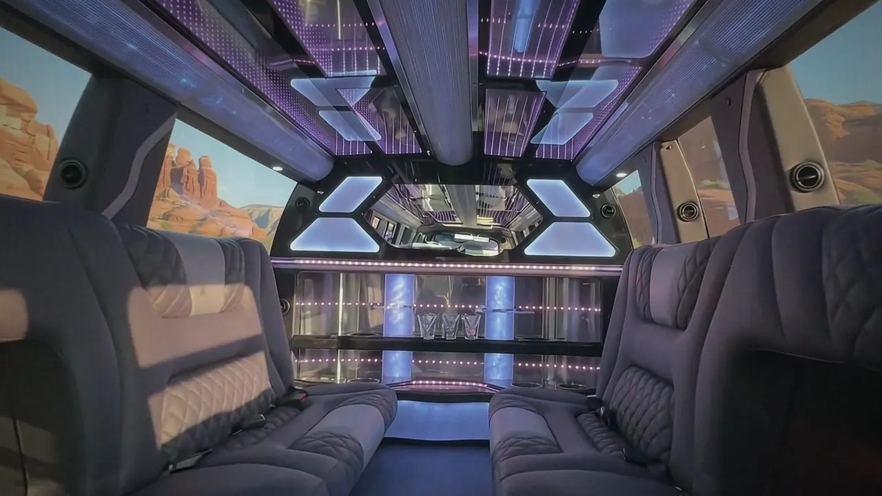 Inside the Cadillac Escalade limo in Johnstown: LED light-show ceiling, leather lounge seating and lit bar